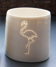 Load image into Gallery viewer, Tropical party present. This ceramic candle votive features a design of a flamingo. Holiday candle, this porcelain tealight holder glows from within once a candle is lit.
