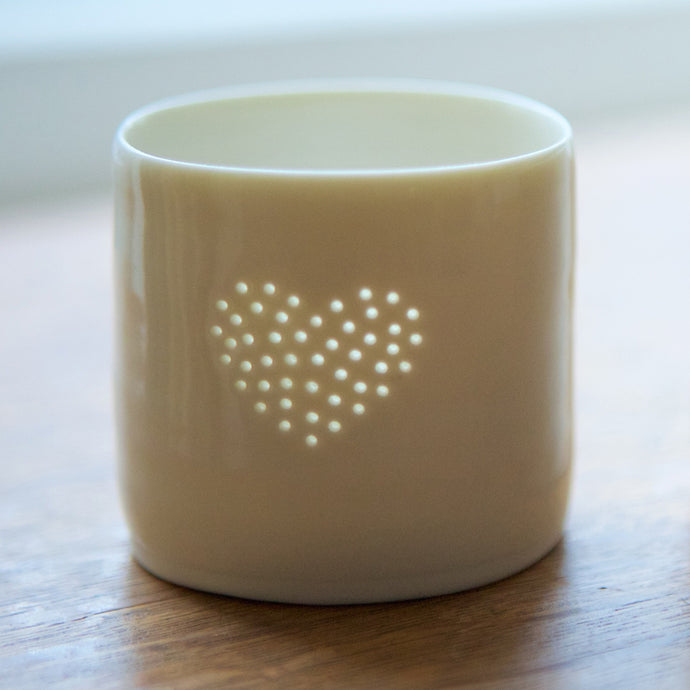 A lovely present this ceramic candle holder is designed with a heart. Porcelain tealight holders as wedding presents, memorials or anniversary gifts.