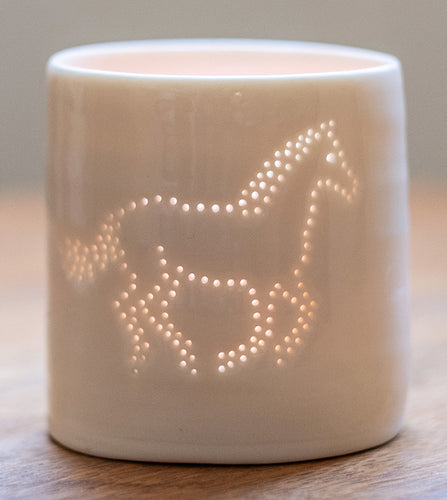 Galloping horse ceramic tealight holder. This porcelain candle holder features an equestrian design, perfect for horse lovers.